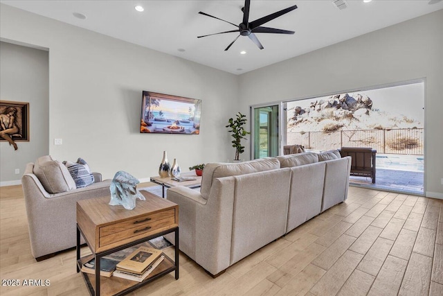 living area featuring recessed lighting, baseboards, light wood-style flooring, and a ceiling fan