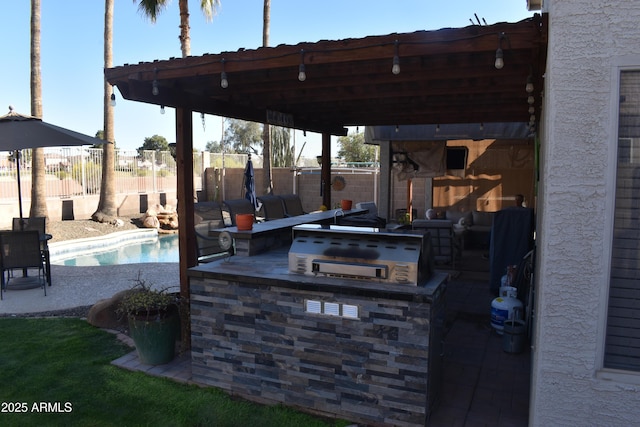 view of patio with fence, a fenced in pool, and an outdoor kitchen