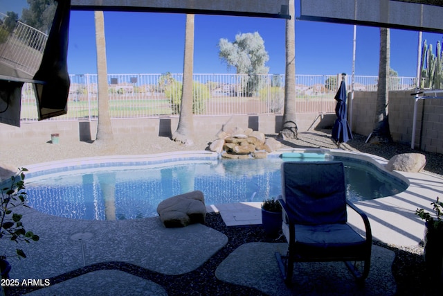 view of pool with a jacuzzi