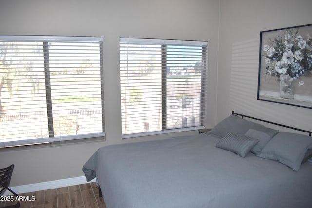 bedroom with wood finished floors and baseboards