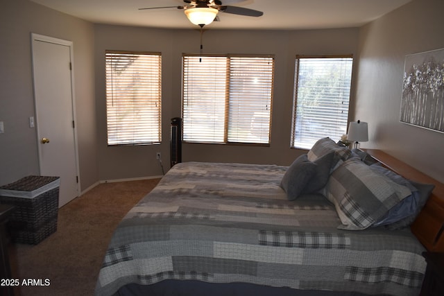 bedroom with multiple windows, carpet, and a ceiling fan