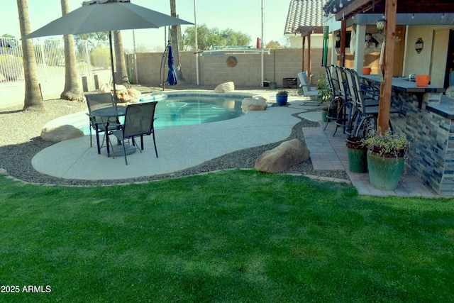 view of swimming pool with a yard, a fenced in pool, a fenced backyard, and a patio area