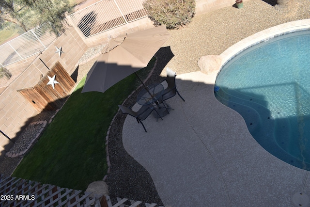 pool with a patio and a fenced backyard