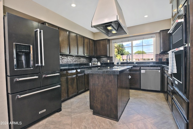 kitchen featuring a center island, sink, stainless steel appliances, extractor fan, and dark brown cabinets