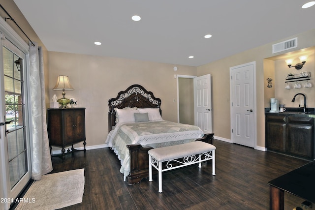 bedroom featuring dark hardwood / wood-style flooring and sink