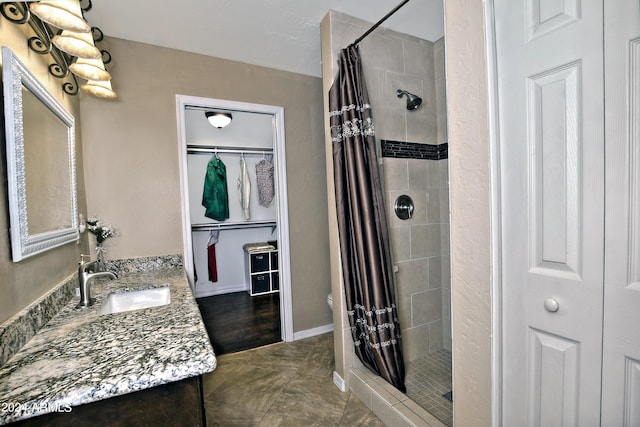 bathroom featuring curtained shower and vanity