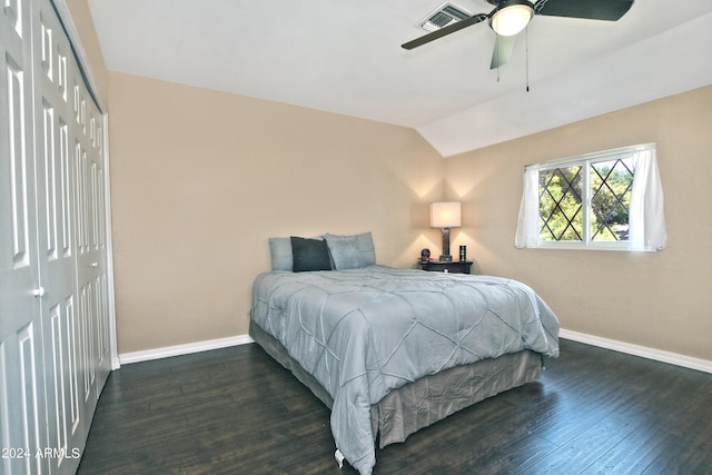 bedroom with a closet, dark hardwood / wood-style floors, ceiling fan, and lofted ceiling