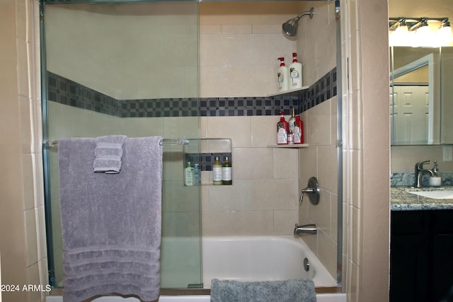 bathroom with vanity and bath / shower combo with glass door