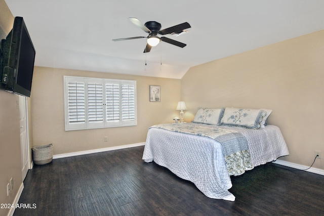 bedroom featuring ceiling fan, dark wood-type flooring, and lofted ceiling