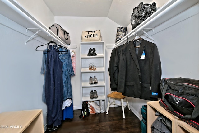 walk in closet featuring dark hardwood / wood-style flooring and lofted ceiling