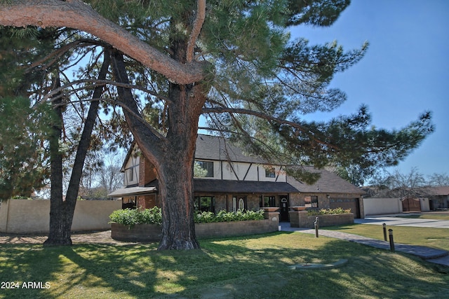 english style home with a front yard