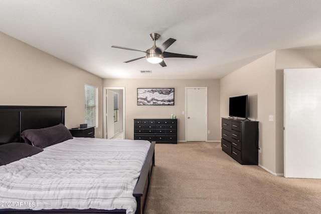 bedroom with light carpet and ceiling fan