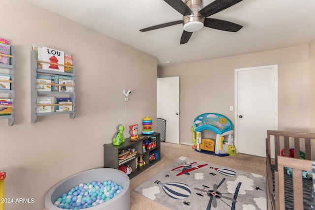 bedroom featuring light colored carpet and ceiling fan