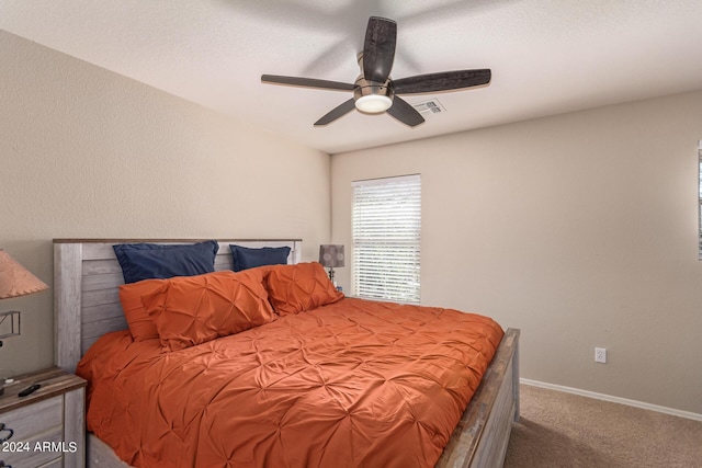 bedroom with ceiling fan and carpet