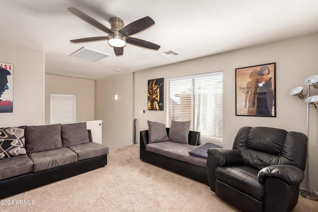 living room with ceiling fan and light carpet