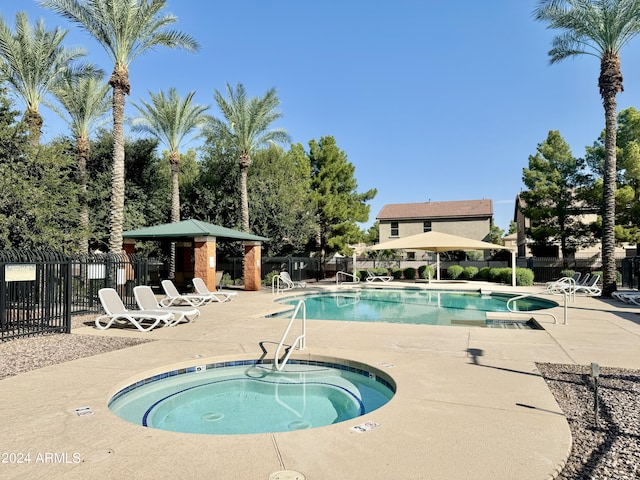 view of pool featuring a gazebo, a patio area, and a hot tub