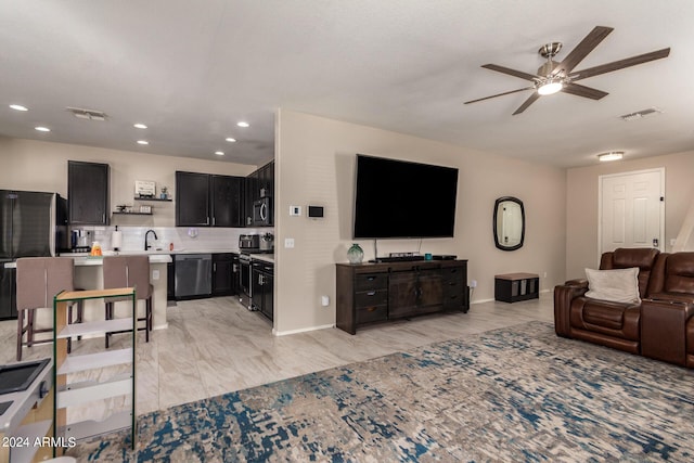 living room with sink and ceiling fan