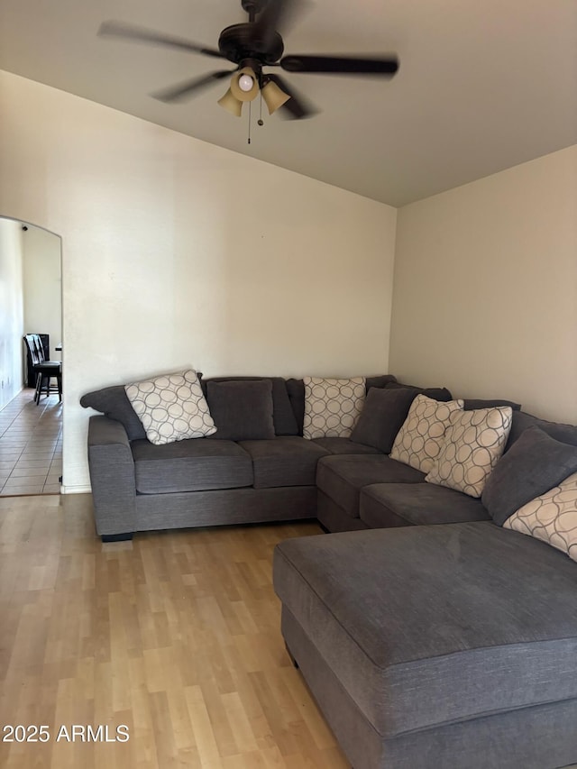 living area featuring a ceiling fan and light wood finished floors