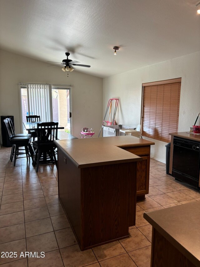 kitchen with a kitchen island, black dishwasher, ceiling fan, and light tile patterned floors