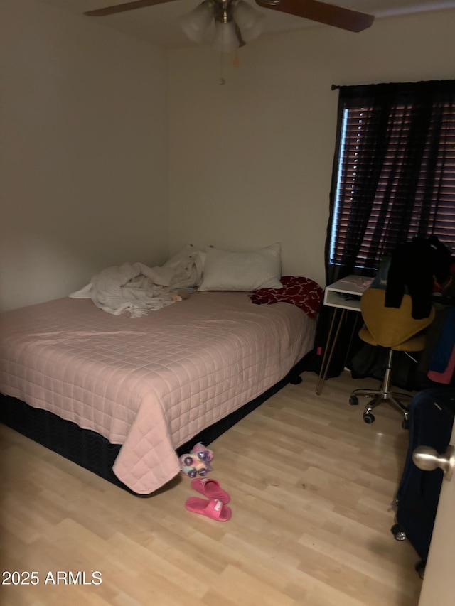 bedroom with a ceiling fan and wood finished floors