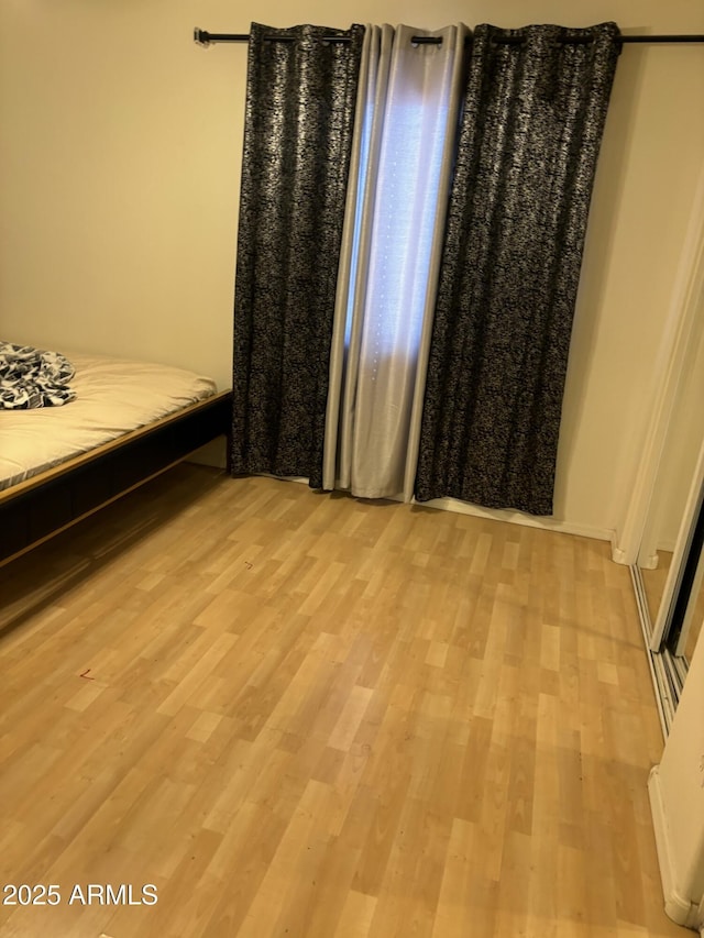 bedroom featuring light wood-style floors