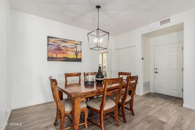 9253 N Firebrick Dr Unit 117, Fountain Hills, AZ 85268 - dining room with light wood-style floors, visible vents, baseboards, and an inviting chandelier