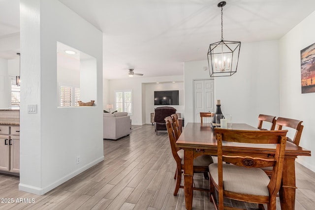 9253 N Firebrick Dr Unit 117, Fountain Hills, AZ 85268 - dining area featuring light wood-style flooring, baseboards, and ceiling fan with notable chandelier