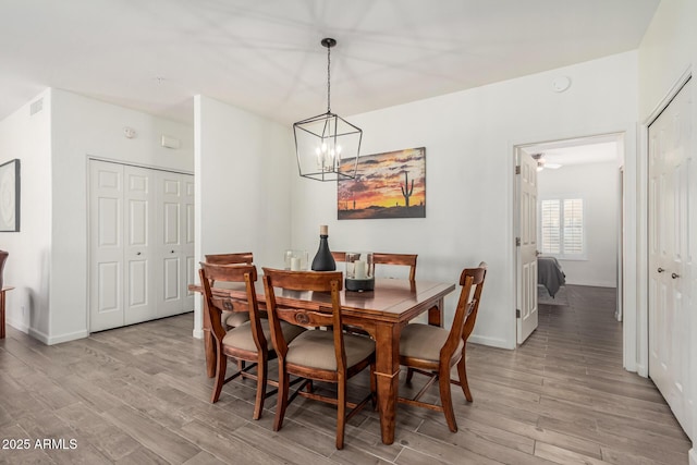 9253 N Firebrick Dr Unit 117, Fountain Hills, AZ 85268 - dining space featuring a chandelier, light wood-style flooring, and baseboards