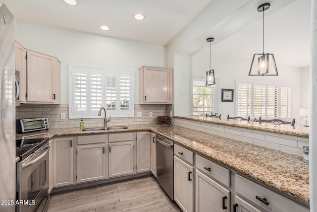 9253 N Firebrick Dr Unit 117, Fountain Hills, AZ 85268 - kitchen featuring light wood finished floors, decorative backsplash, a sink, and appliances with stainless steel finishes