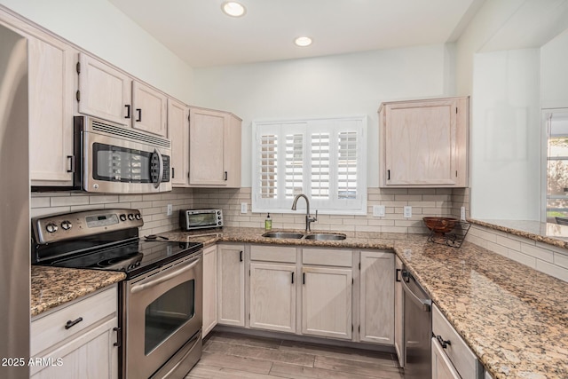 9253 N Firebrick Dr Unit 117, Fountain Hills, AZ 85268 - kitchen with decorative backsplash, light stone countertops, stainless steel appliances, and a sink