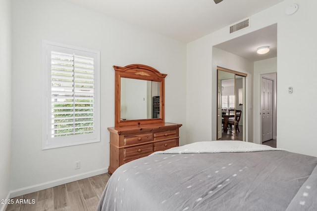 9253 N Firebrick Dr Unit 117, Fountain Hills, AZ 85268 - bedroom with light wood finished floors, baseboards, visible vents, and multiple windows