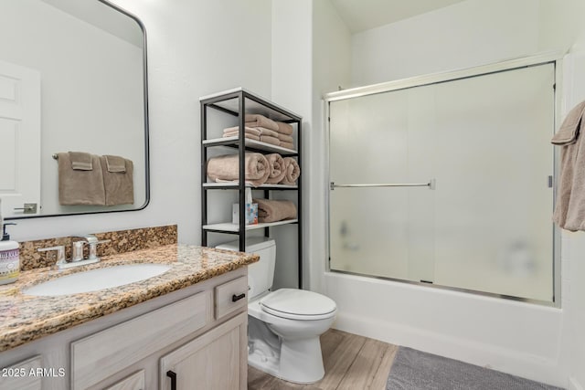 9253 N Firebrick Dr Unit 117, Fountain Hills, AZ 85268 - bathroom with wood finished floors, vanity, shower / bath combination with glass door, and toilet