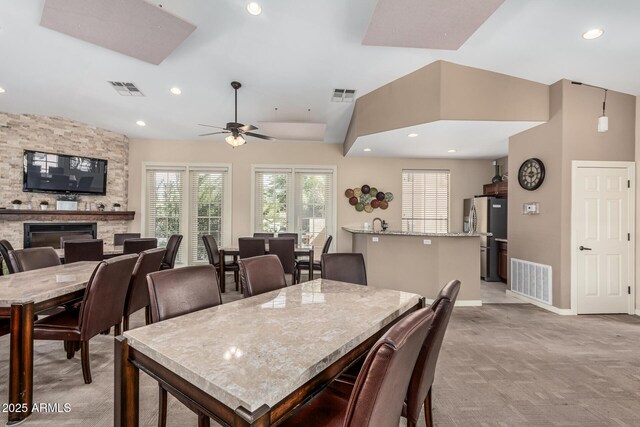9253 N Firebrick Dr Unit 117, Fountain Hills, AZ 85268 - dining room featuring lofted ceiling with skylight, visible vents, and light colored carpet