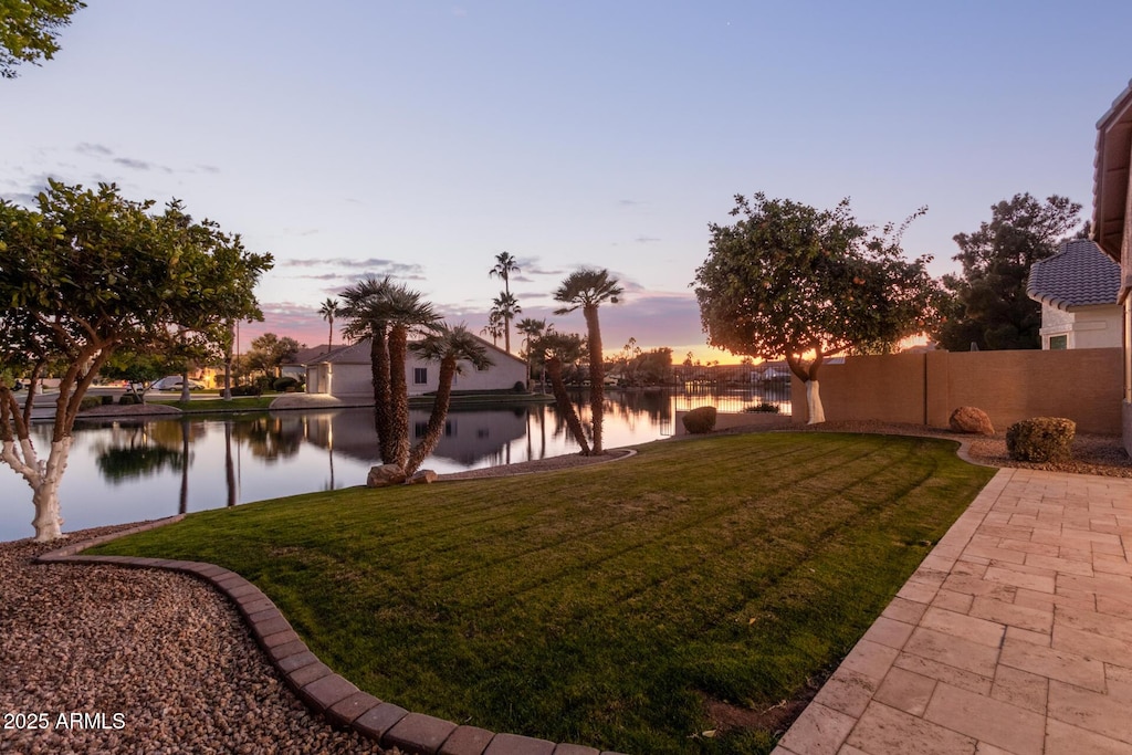 yard at dusk with a water view