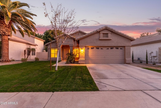 view of front facade with a lawn and a garage