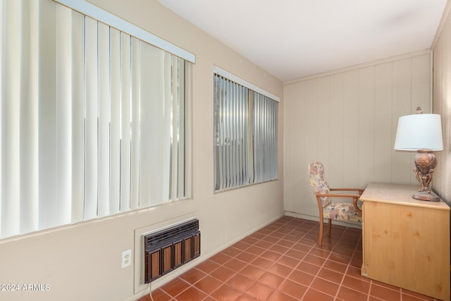 unfurnished office featuring tile patterned floors and wooden walls