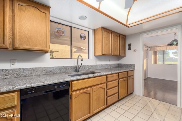 kitchen featuring light tile patterned floors, black dishwasher, and sink