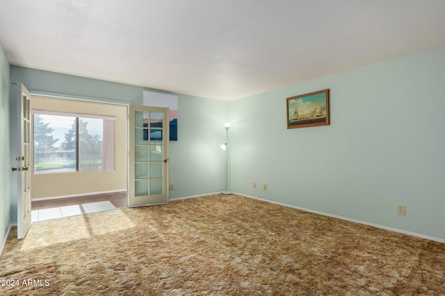 unfurnished room featuring carpet flooring and french doors