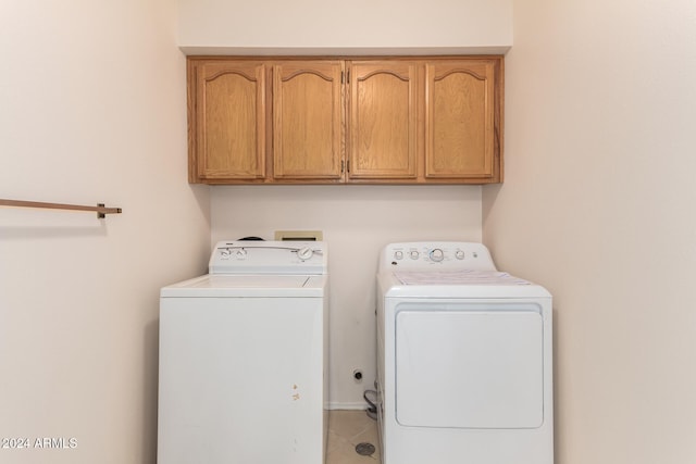 laundry area with cabinets, independent washer and dryer, and tile patterned flooring