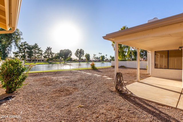 view of yard with a patio area and a water view