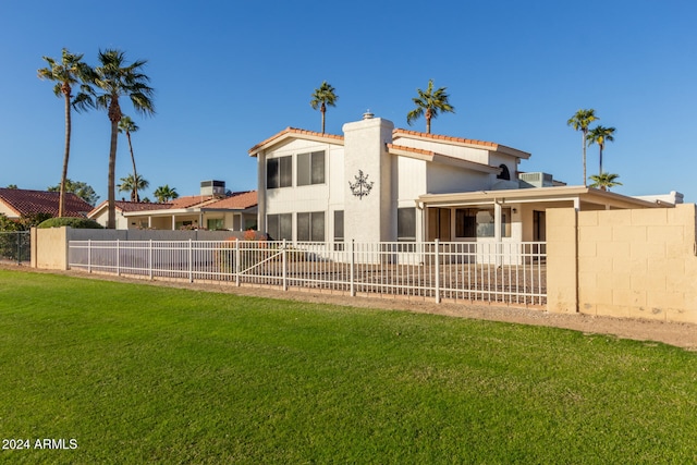 rear view of property with a lawn