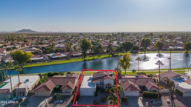 drone / aerial view featuring a water and mountain view