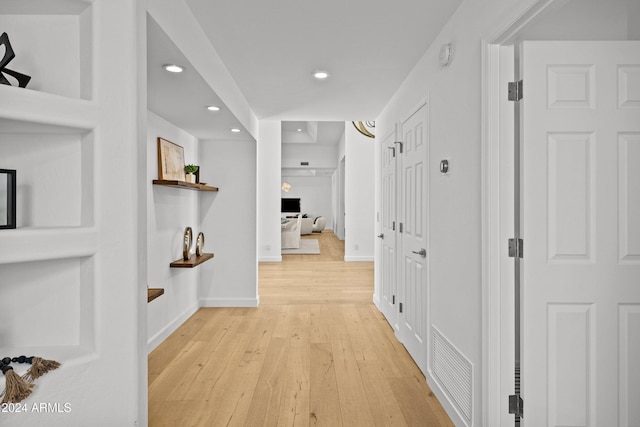 hall with light hardwood / wood-style floors