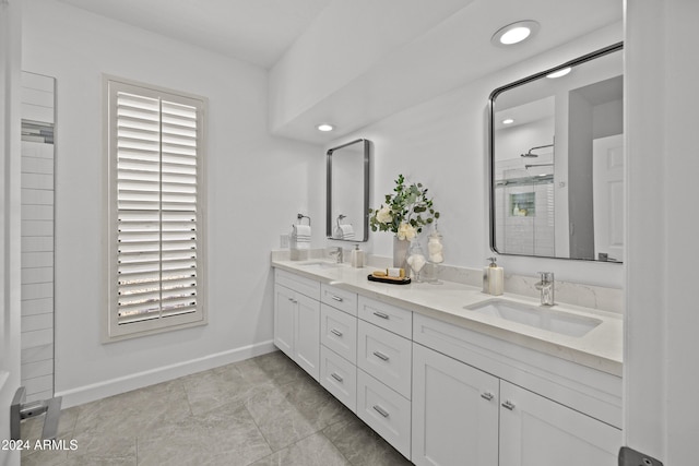 bathroom with a shower, tile patterned flooring, and vanity