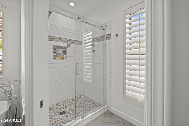 bathroom with tile patterned floors and a shower with shower door