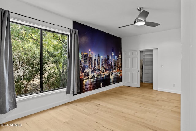 unfurnished room featuring hardwood / wood-style floors and ceiling fan