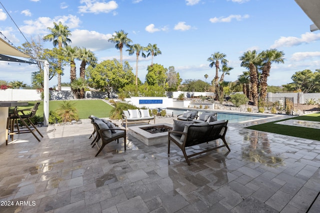 view of patio / terrace with an outdoor living space with a fire pit and a fenced in pool