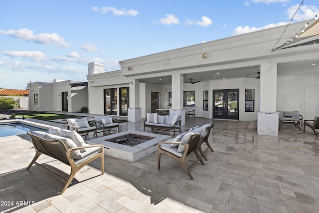 view of patio / terrace with an outdoor living space with a fire pit and ceiling fan