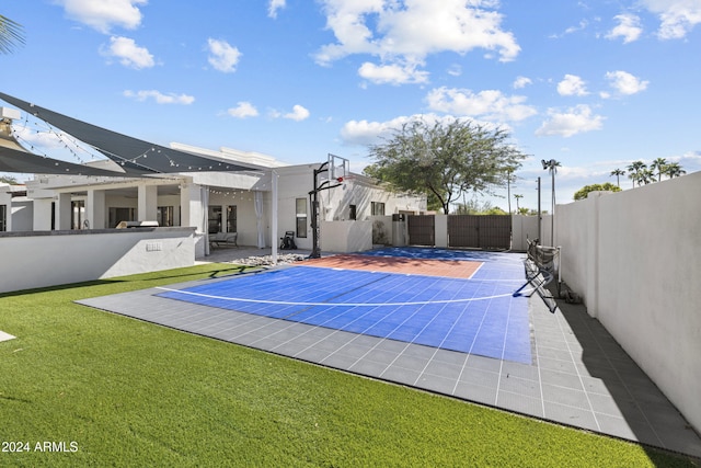 view of sport court featuring a yard