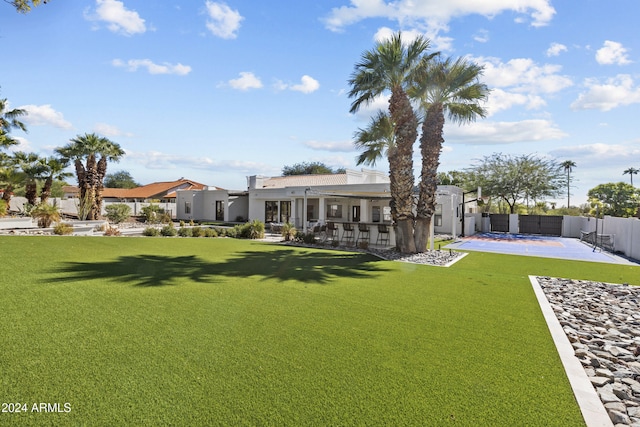 back of property featuring a lawn and a patio